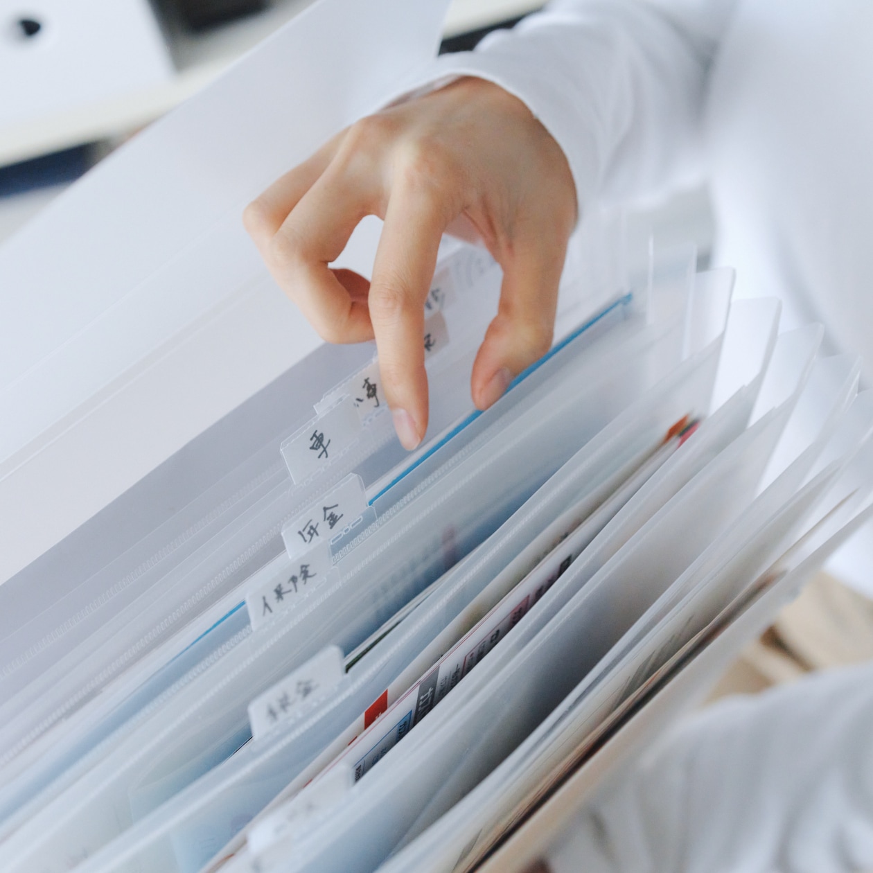 見出しをつけたファイルケースと仕分けられた書類