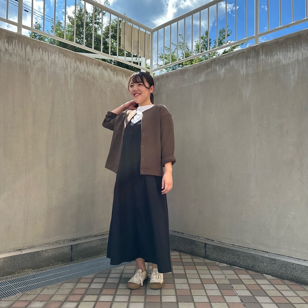 二重編みスウェットカーディガンを着る女性スタッフ