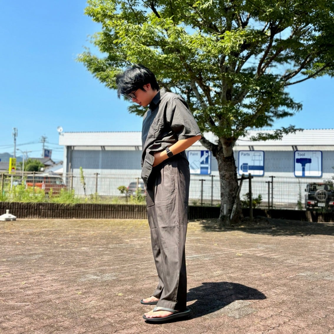 なめらか五分袖シャツとツータックストレートパンツのセットアップを着用したスタッフの写真です。