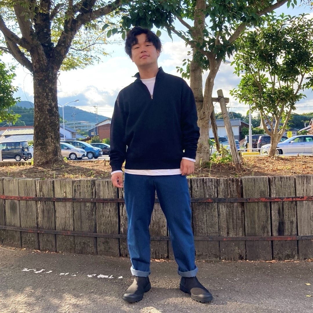 二重編みハーフジッププルオーバーを着用したスタッフの写真です。