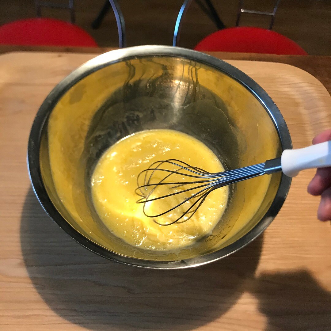 卵とバターを混ぜている画像