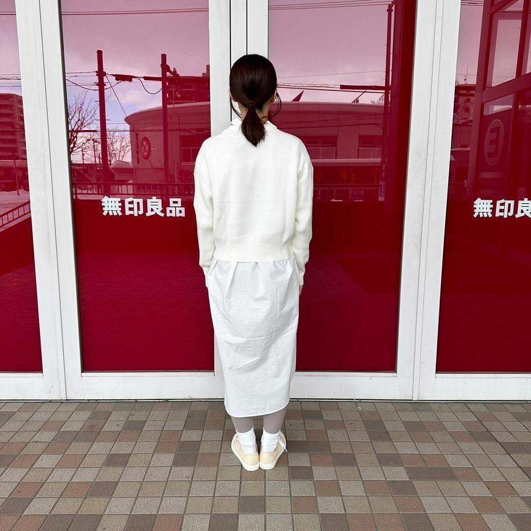クルーネックセーターを着た女性スタッフの背面