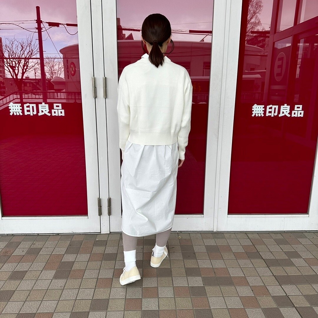 クルーネックセーターを着た女性スタッフの背面