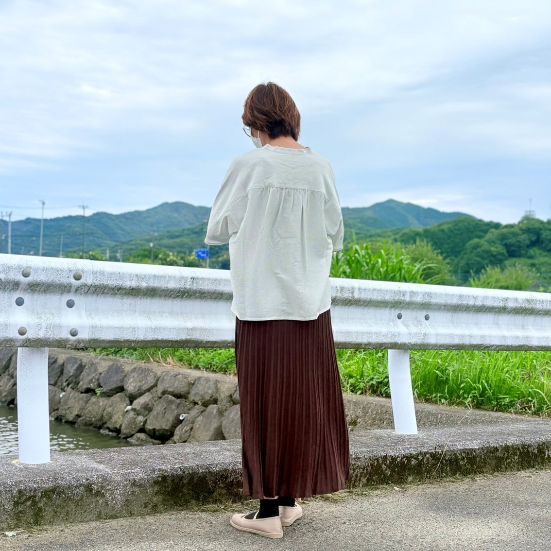 なめらか5分袖ブラウスになめらかニットフレアスカートを合わせたコーディネートのスタッフの写真です。
