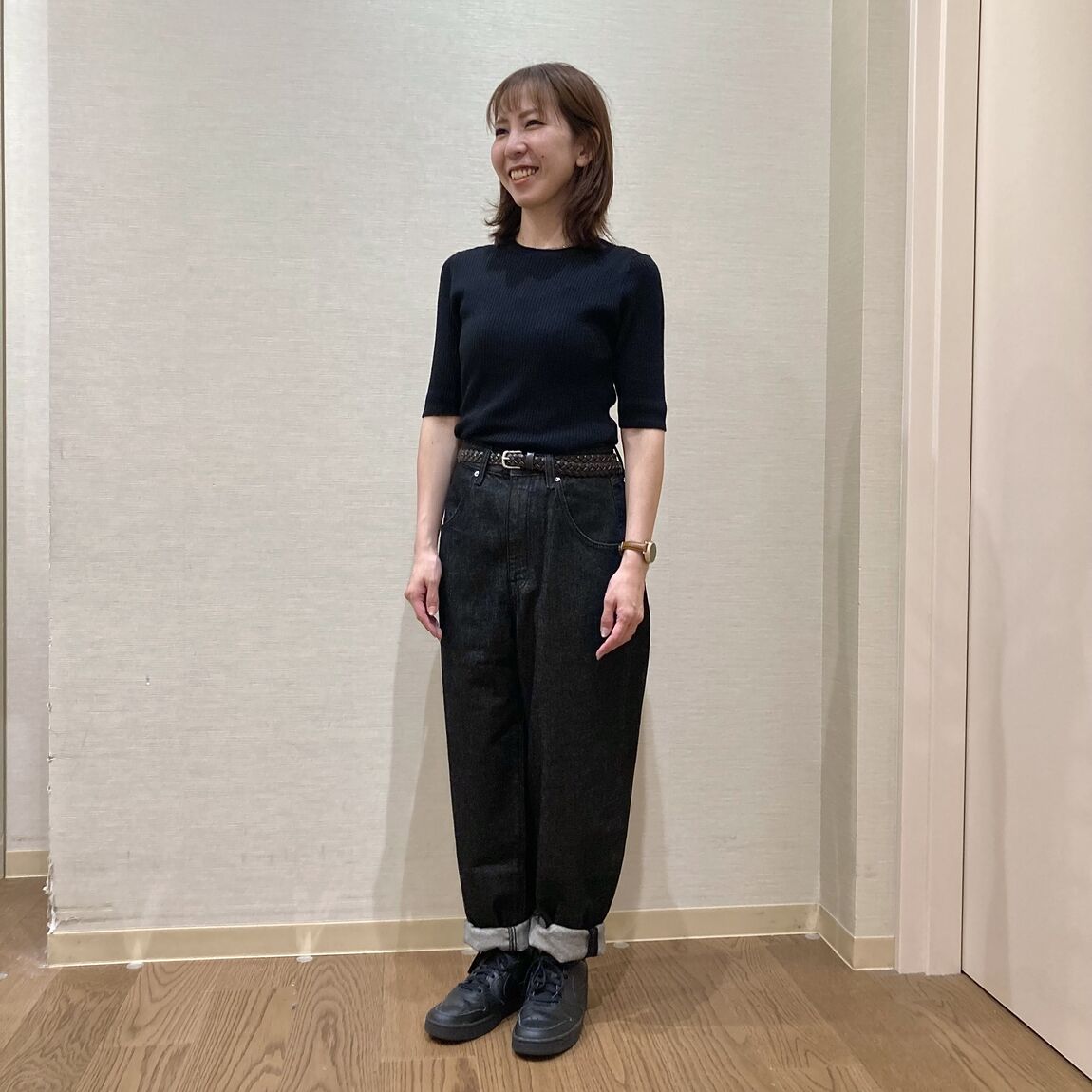 黒いニットと黒いデニムを着用した女性
