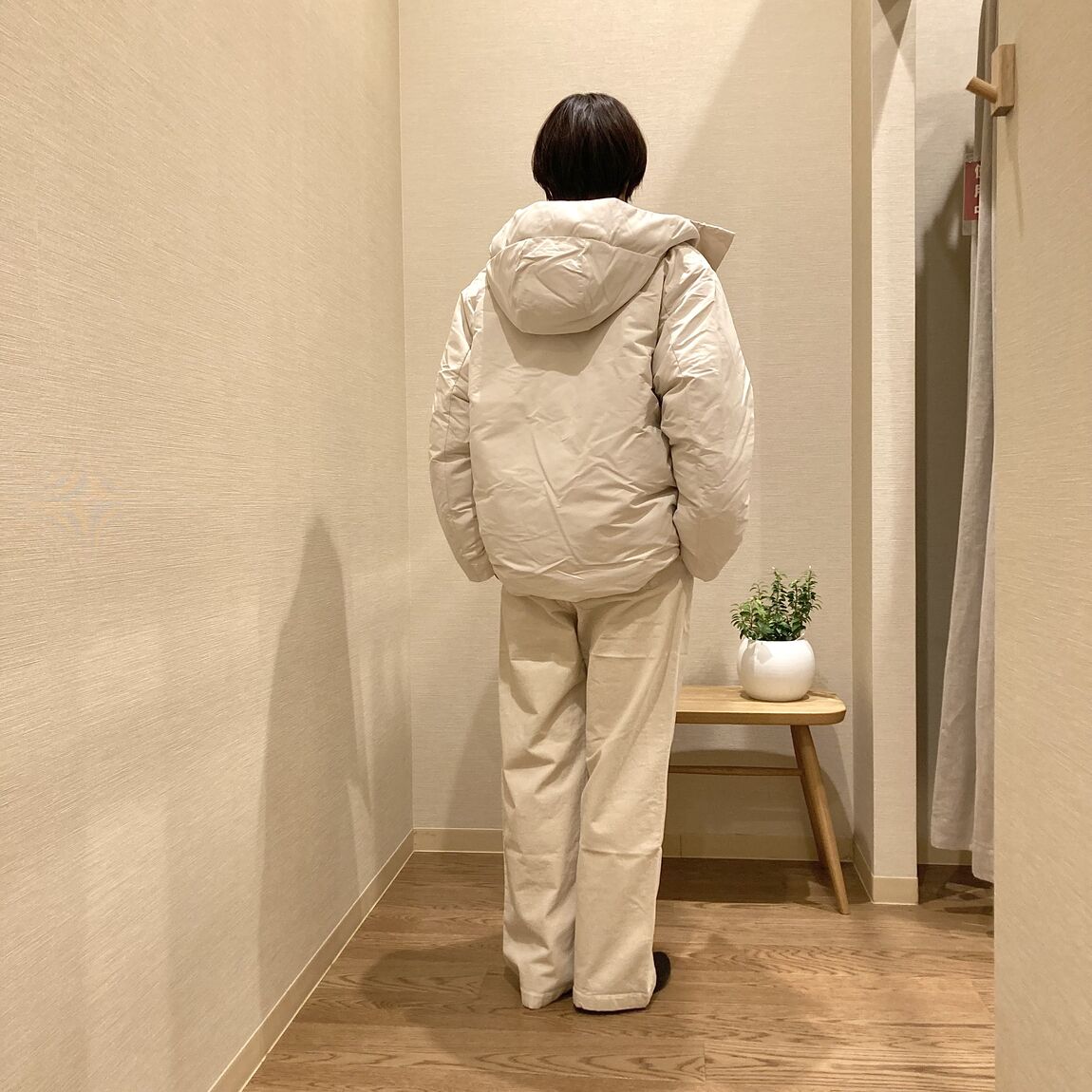 ブルーのセーターと白のダウンジャケットを着用したじ