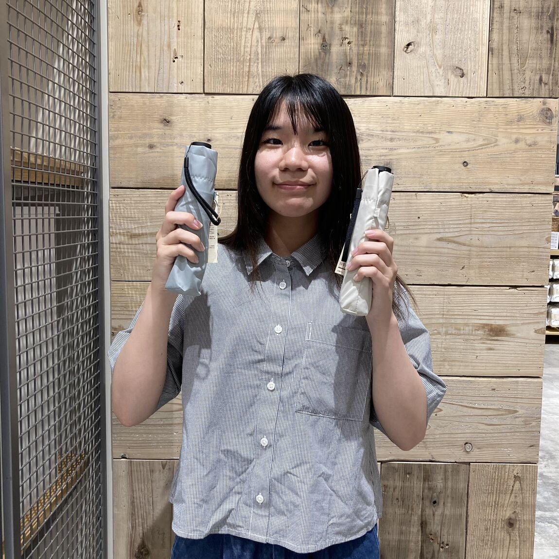 両手に傘を持つ女性