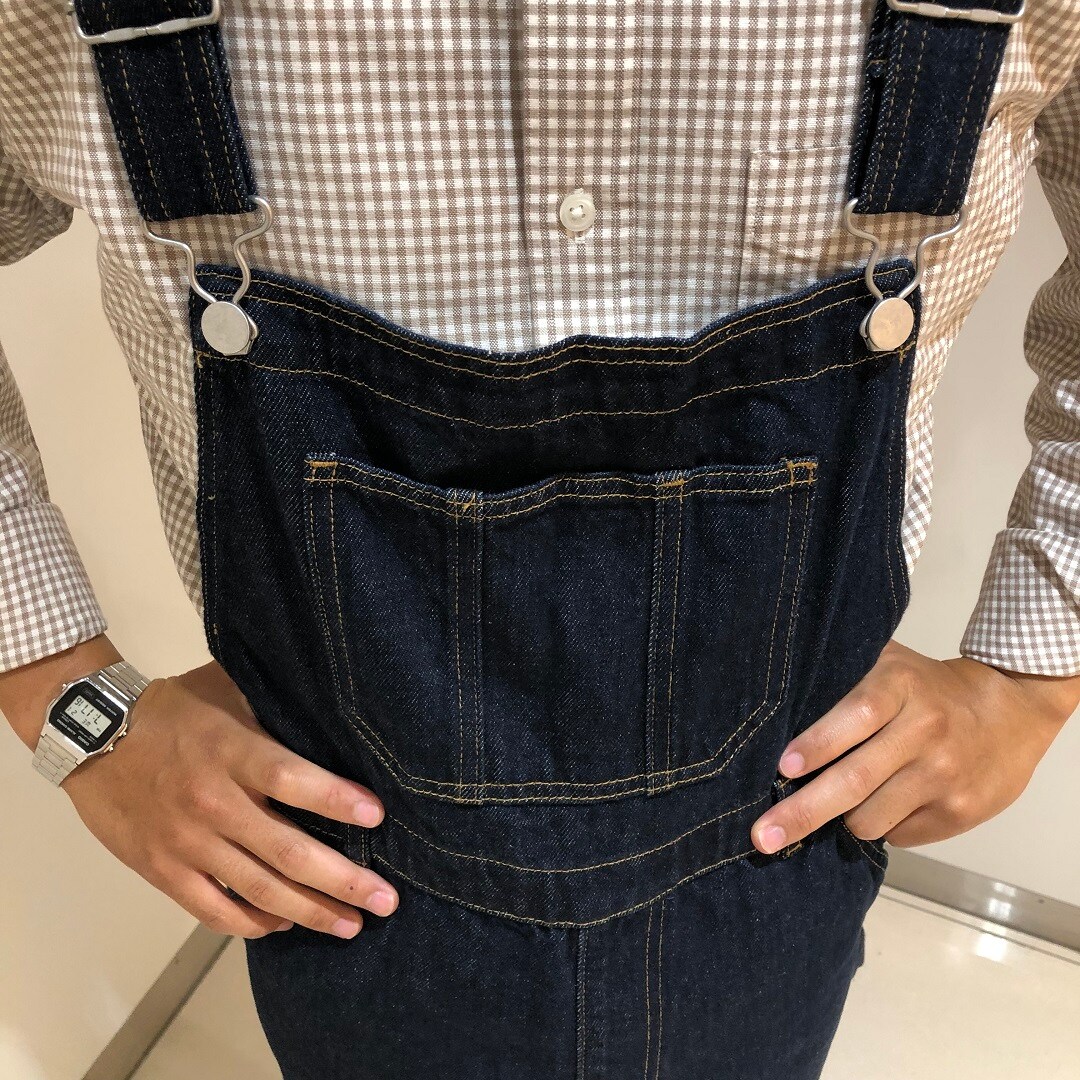 オーバーオールを着た男性が立っている写真
