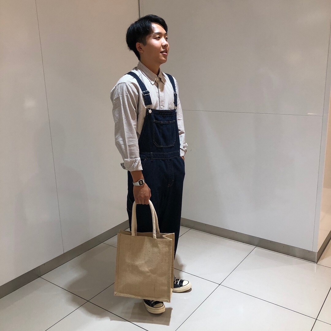 オーバーオールを着た男性が立っている写真