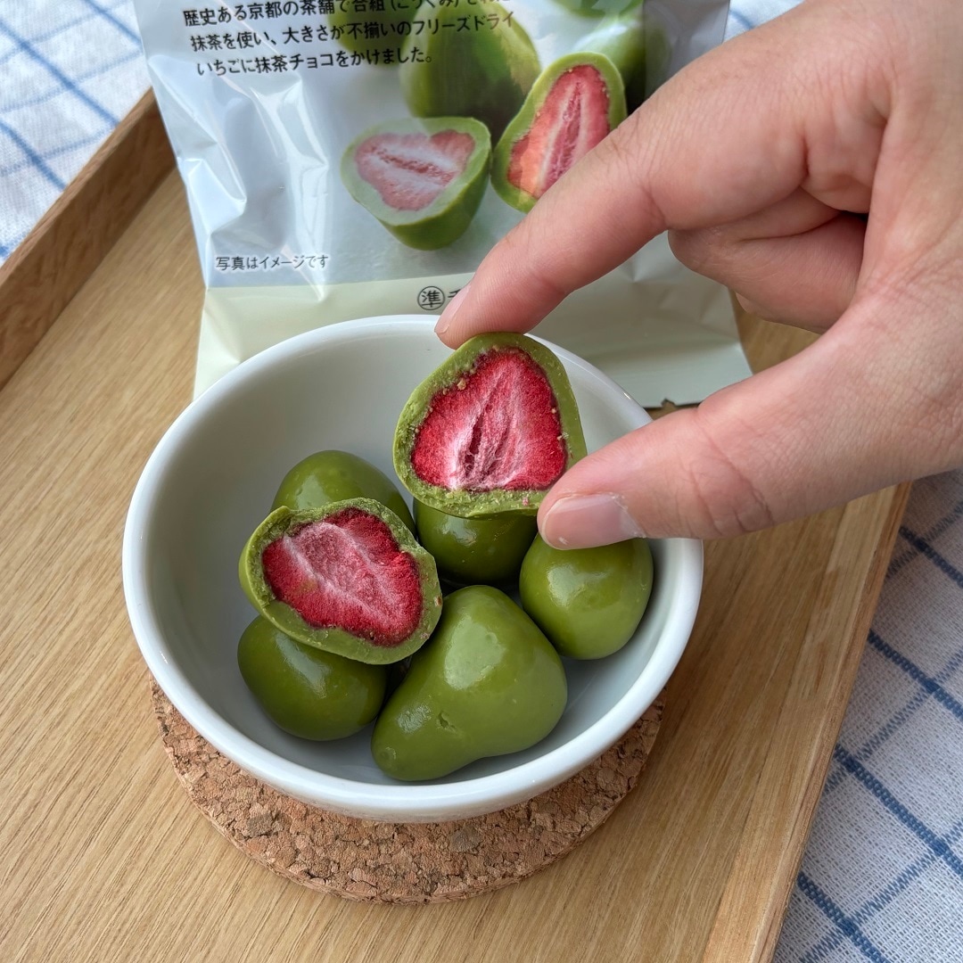 不揃い宇治抹茶チョコがけいちごを一粒持っている様子