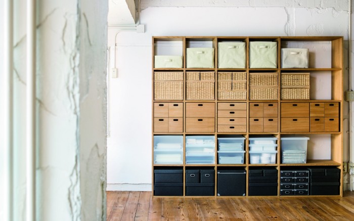 A series of stacking shelves filled with MUJI's storage products.