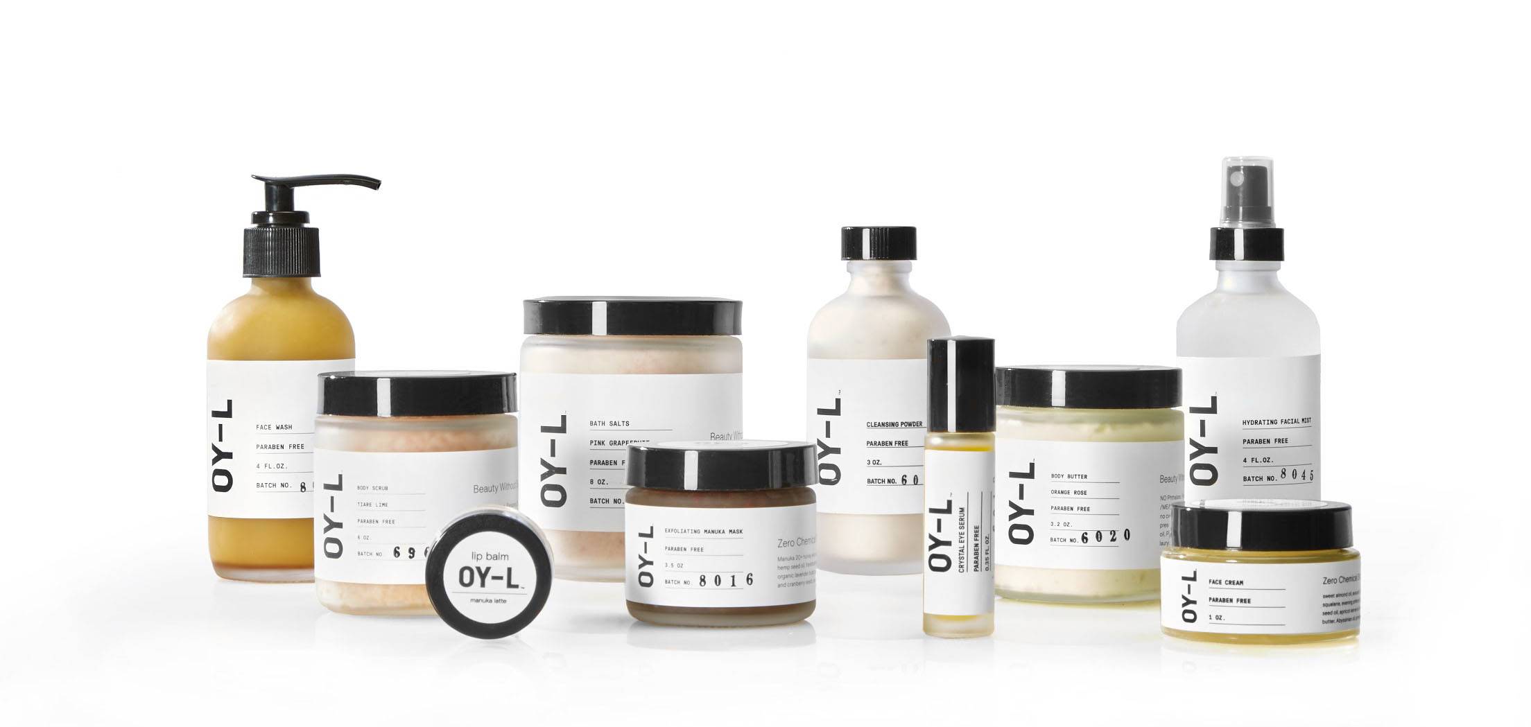 OY-L Skincare product line. Several white bottles and containers with black lids and the letters OY-L centered on the front.